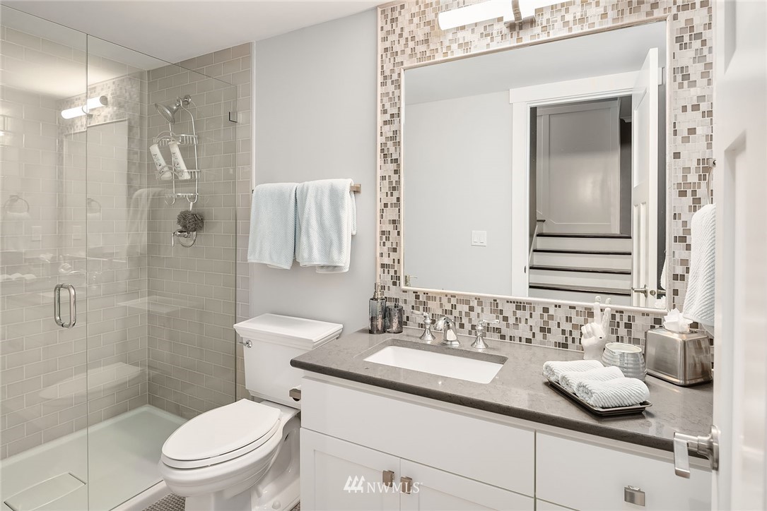 3112 Hunts Point Circle Hunts Point, WA 98004 - Photo 36 of 40 a bathroom with a granite countertop sink a toilet and shower