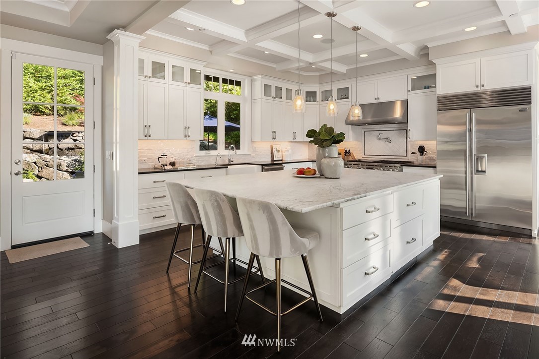 3112 Hunts Point Circle Hunts Point, WA 98004 - Photo 9 of 40 a kitchen with stainless steel appliances kitchen island granite countertop a stove a sink a refrigerator and white cabinets with wooden floor
