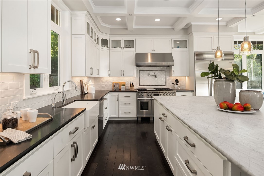 3112 Hunts Point Circle Hunts Point, WA 98004 - Photo 10 of 40 a large kitchen with stainless steel appliances lots of counter space and wooden floor