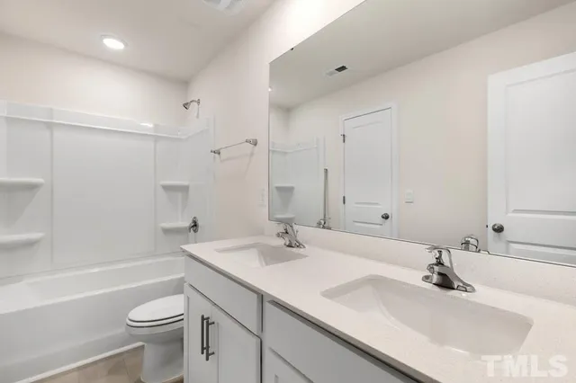 a bathroom with a granite countertop sink mirror and shower