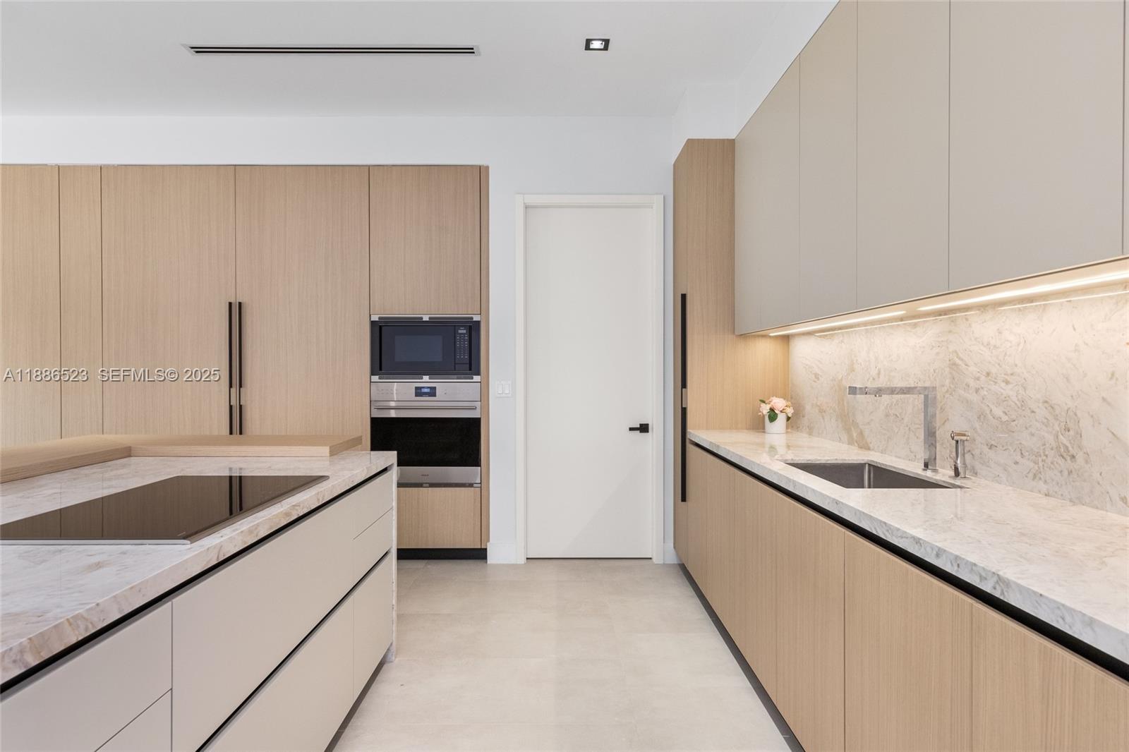 17301 Southwest 52nd Court Southwest Ranches, FL 33331 - Photo 15 of 47 a large kitchen with a sink and a large mirror