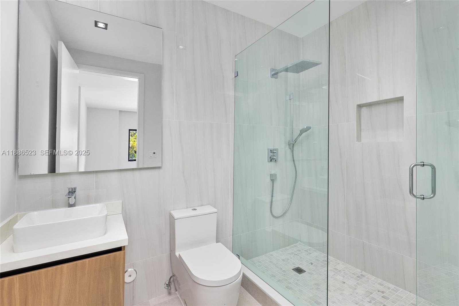 17301 Southwest 52nd Court Southwest Ranches, FL 33331 - Photo 31 of 47 a bathroom with a shower sink vanity mirror and toilet