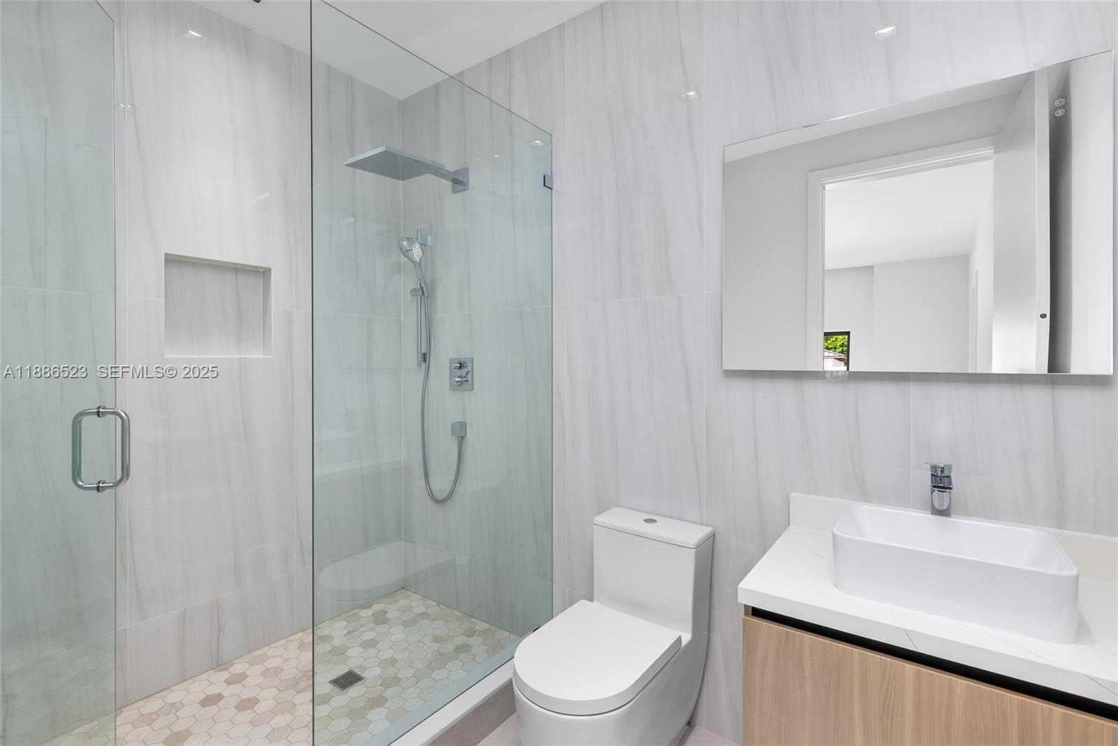 17301 Southwest 52nd Court Southwest Ranches, FL 33331 - Photo 32 of 47 a bathroom with a sink a toilet and shower