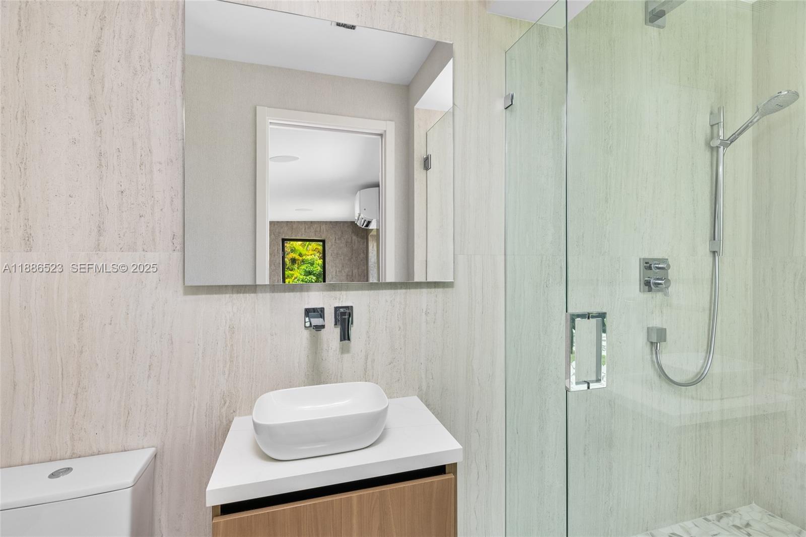 17301 Southwest 52nd Court Southwest Ranches, FL 33331 - Photo 34 of 47 a bathroom with a sink and a mirror