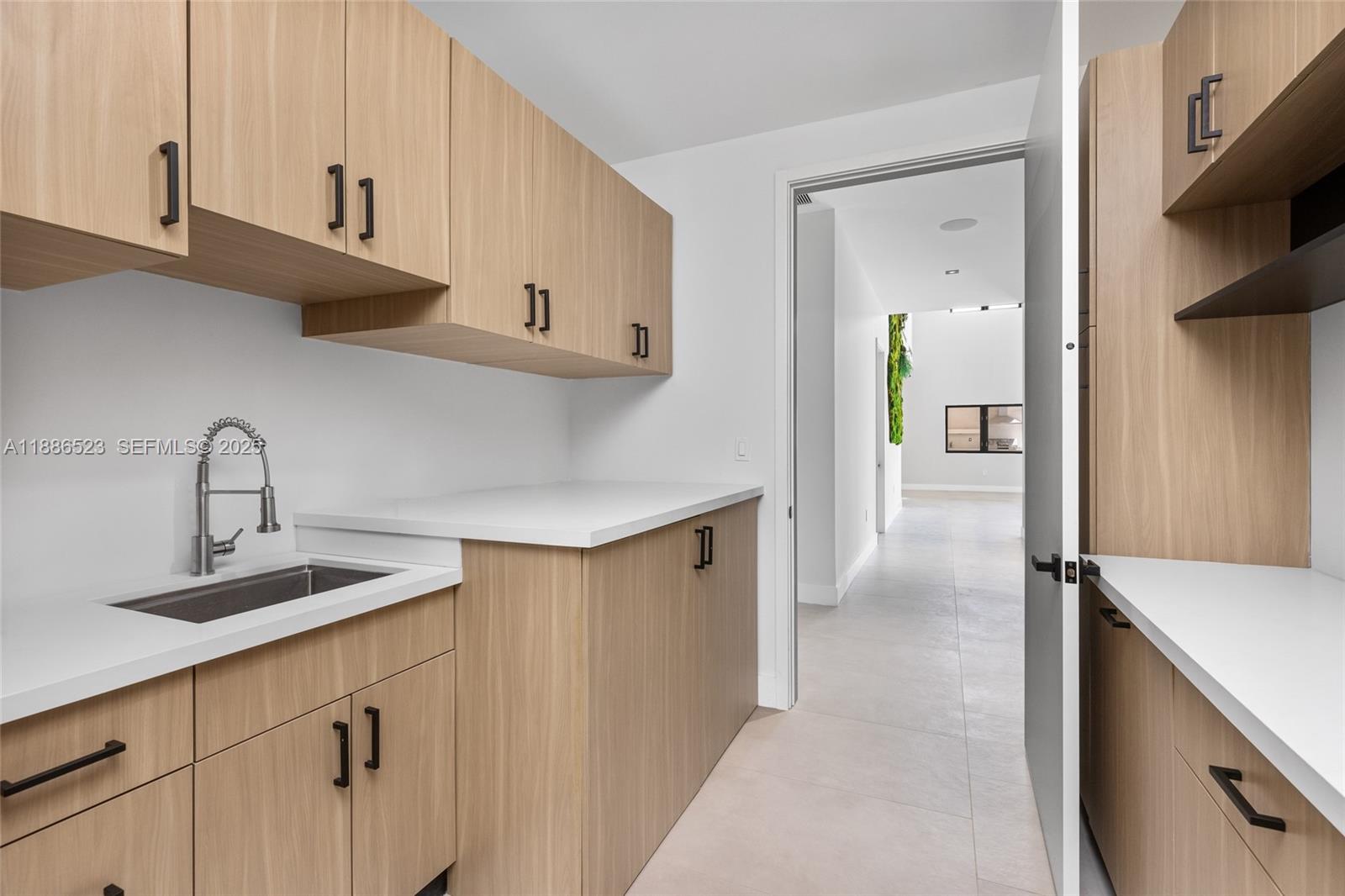 17301 Southwest 52nd Court Southwest Ranches, FL 33331 - Photo 35 of 47 a kitchen with sink cabinets and stove