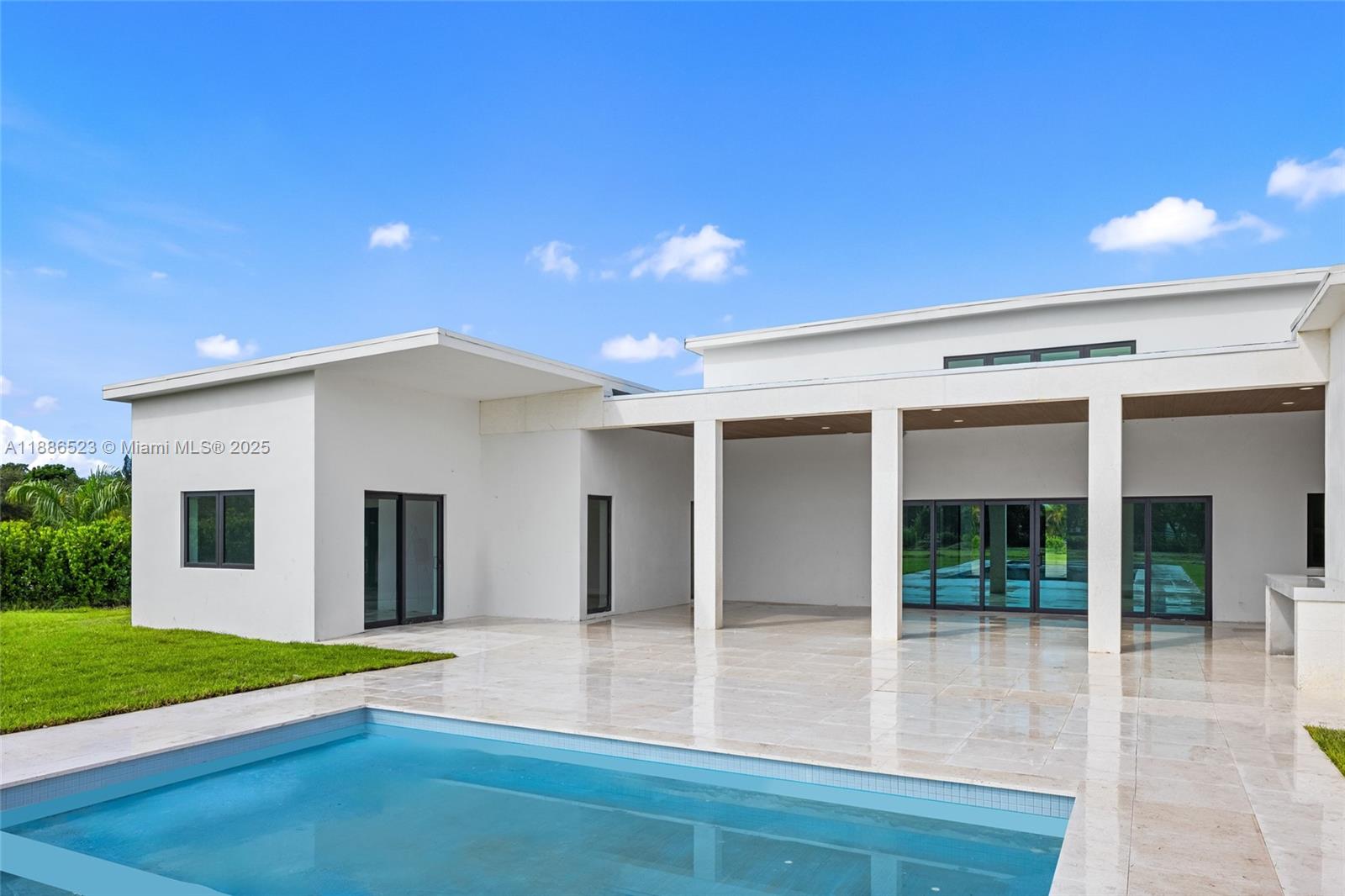 17301 Southwest 52nd Court Southwest Ranches, FL 33331 - Photo 47 of 47 a view of a house with a backyard and a patio