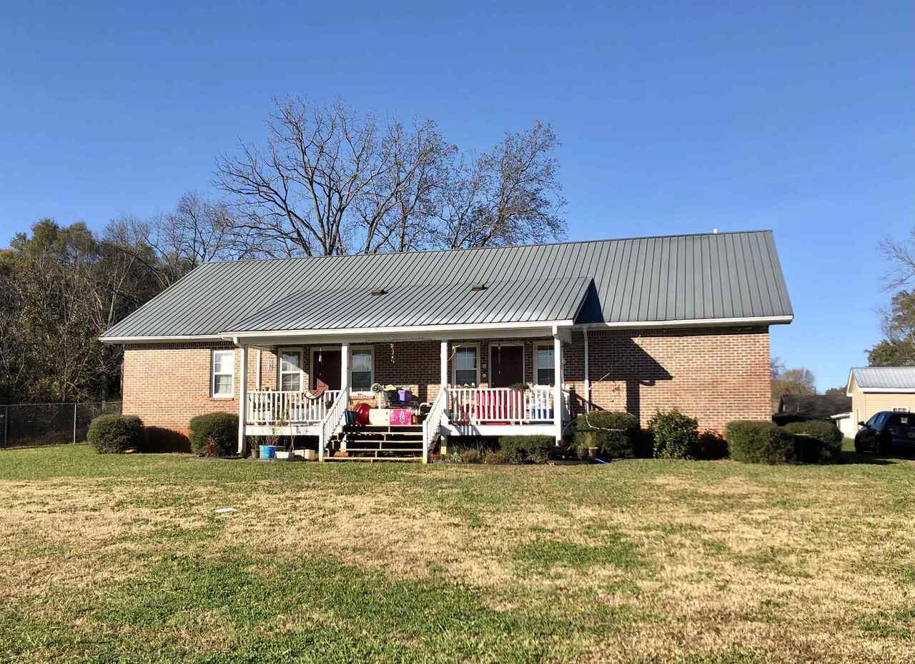 18 Lee Street, Unit 16 Cave Spring, GA 30124 - Photo 1 of 1 a front view of a house with a garden and trees