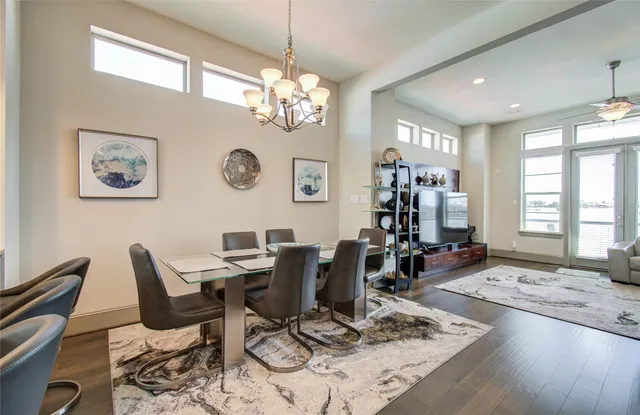 a view of a dining room with furniture a chandelier and wooden floor