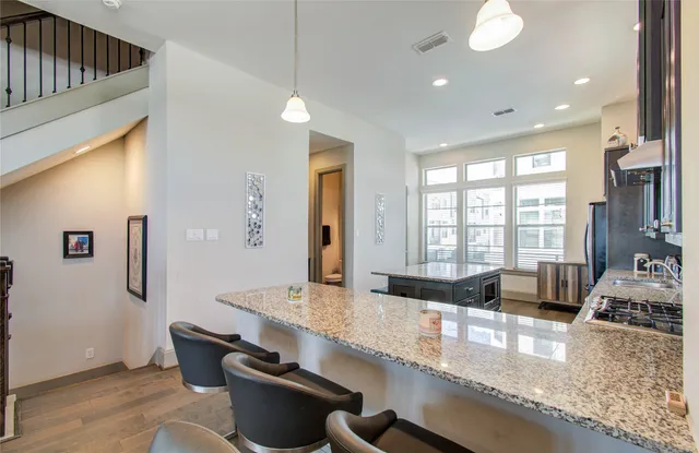 a kitchen with stainless steel appliances granite countertop a stove sink and cabinets