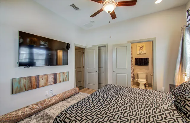 a bedroom with a bed and a flat screen tv