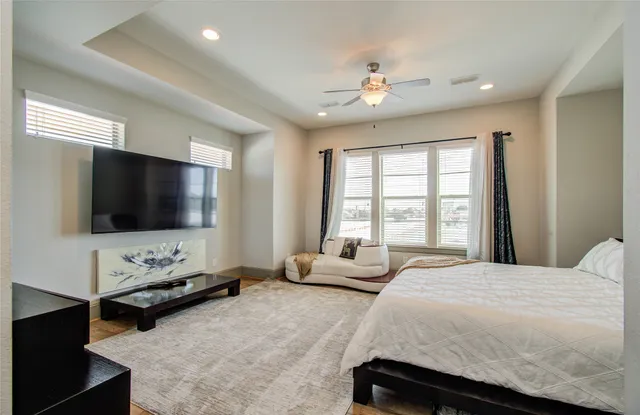 a spacious bedroom with a bed and window