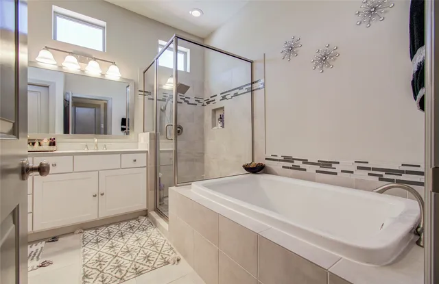 a bathroom with a double vanity sink mirror and shower
