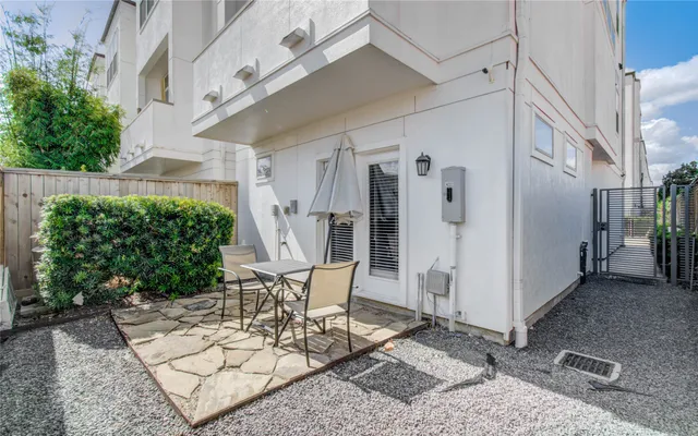 a patio with a table and chairs