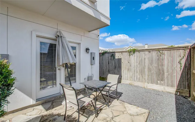 a backyard of a house with table and chairs