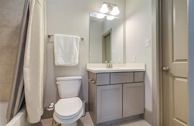 a white toilet sitting next to a bath tub