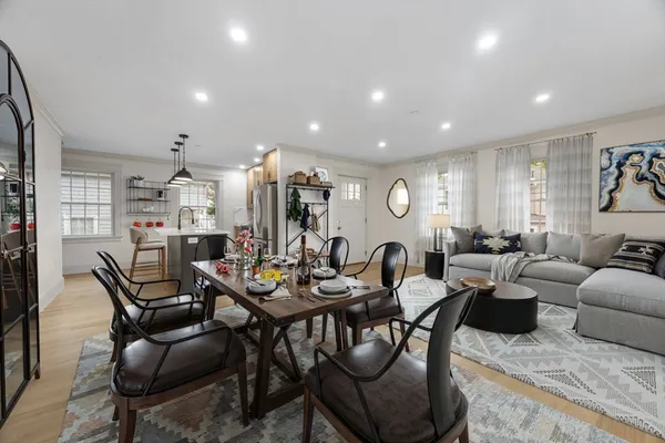 a living room with furniture kitchen and a window