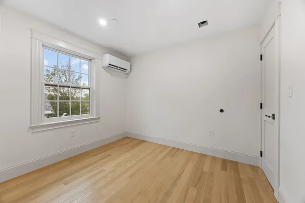 a view of a room with wooden floor and windows