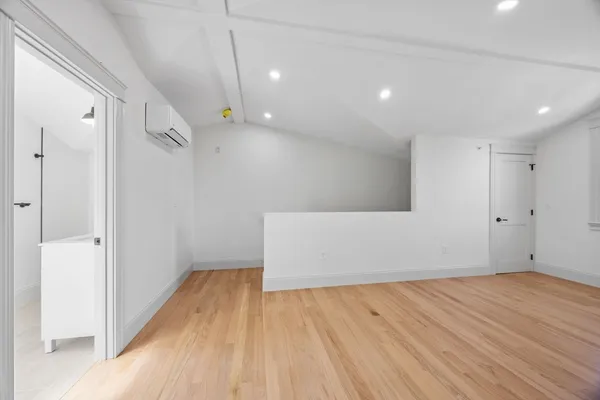 a view of empty room with wooden floor