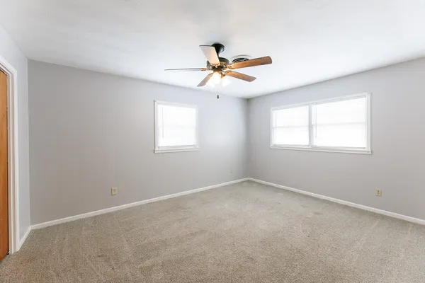 a view of a house with wooden fence