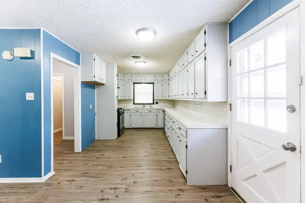 a kitchen with a refrigerator a sink and cabinets