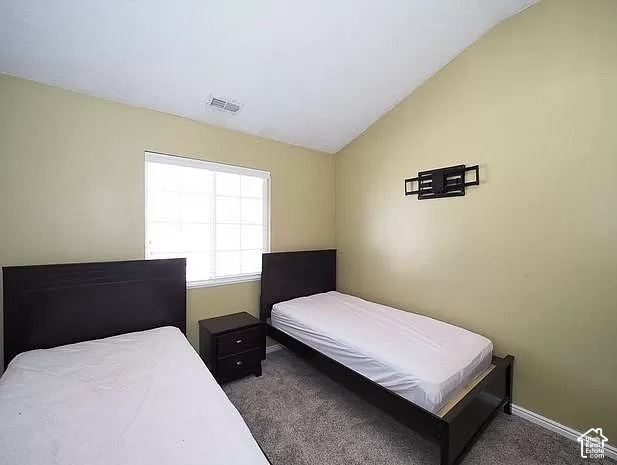 13548 South Villa Rosa Way Draper, UT 84020 - Photo 17 of 28 Room featuring a vaulted ceiling, light-colored walls, and textured carpeting