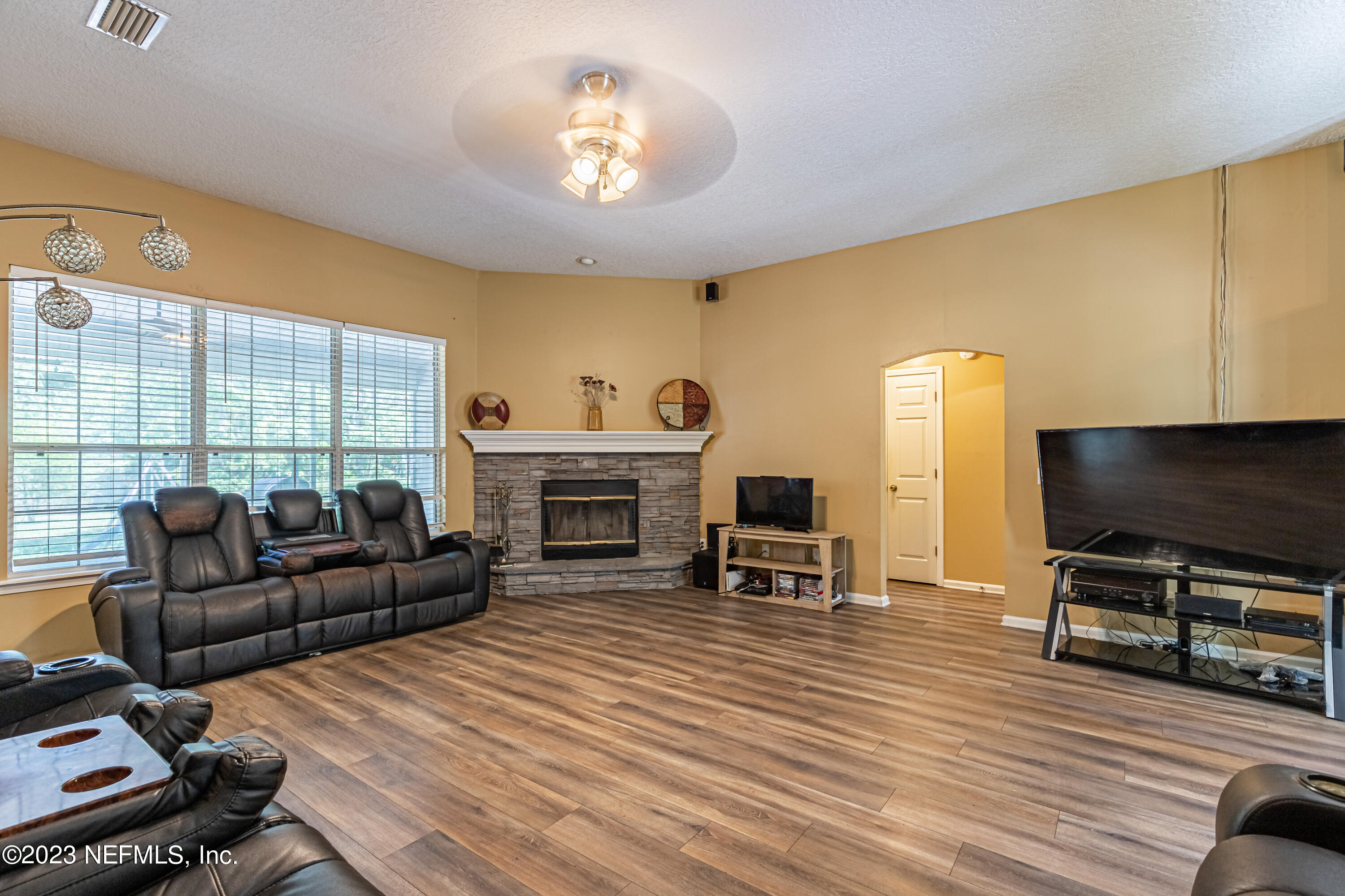 1094 Cactus Cut Road Middleburg, FL 32068 - Photo 6 of 32 a living room with furniture a fireplace and a flat screen tv