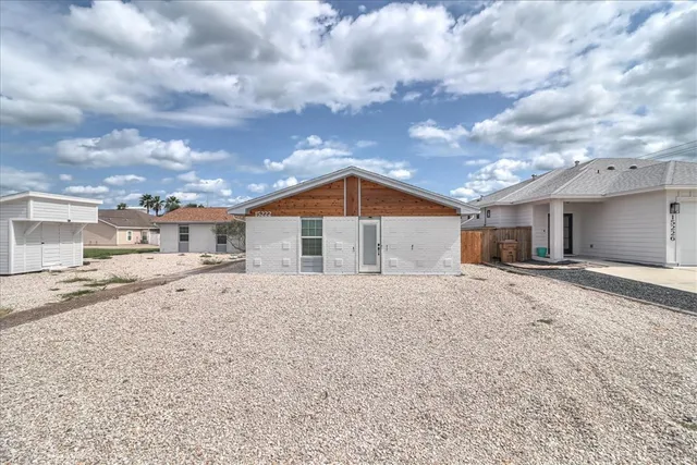 a view of a house next to a road and a big yard