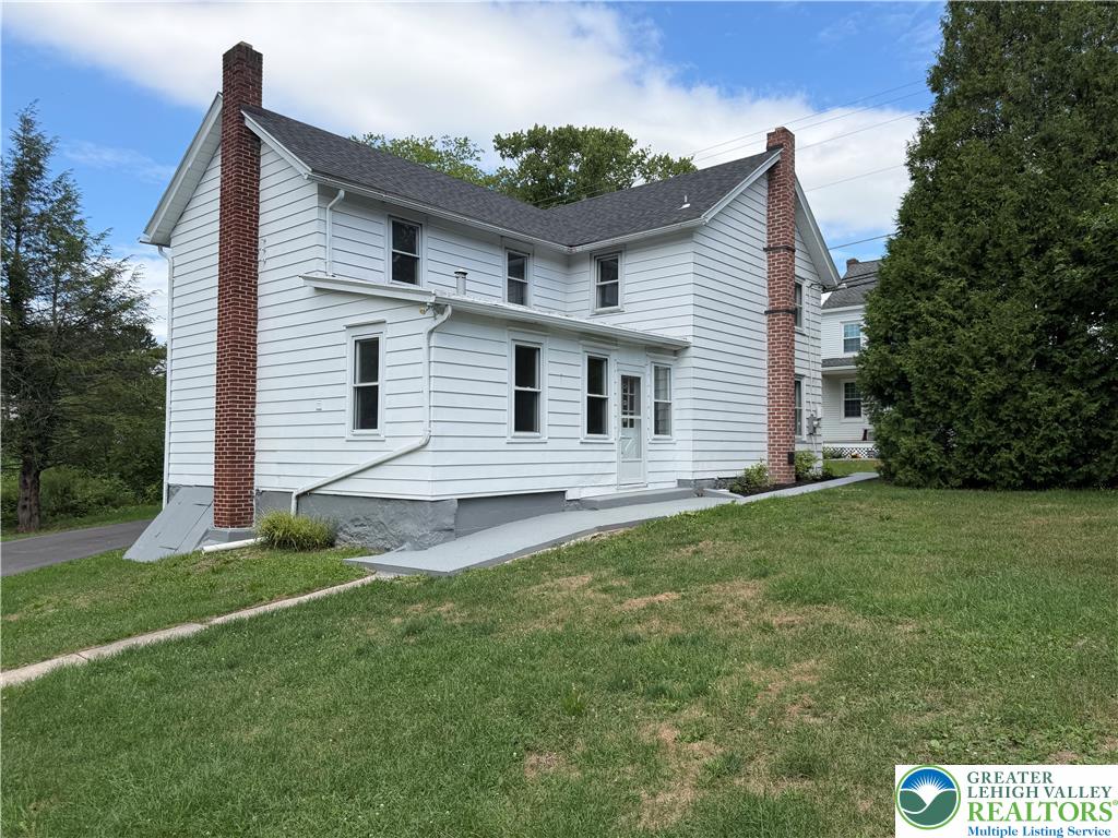 5720 Memorial Road Germansville, PA 18053 - Photo 1 of 29 A classic white-sided residence with prominent brick chimneys sits on a gently sloping green lot.