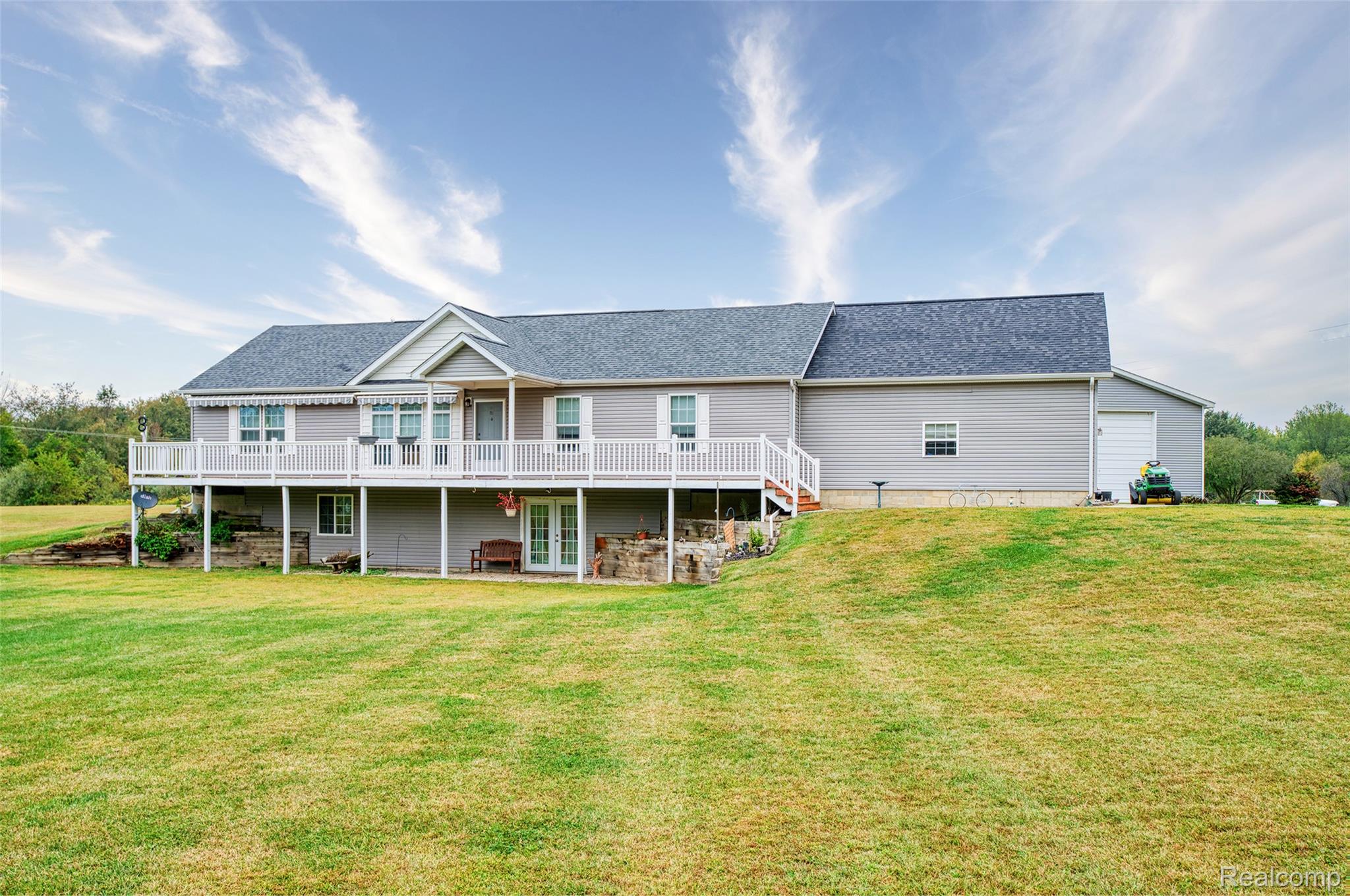 5601 West Lovejoy Road Byron, MI 48418 - Photo 1 of 40 Back of property with roof with shingles, a lawn, and a deck