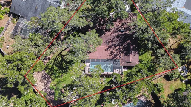 an aerial view of a house with lots of trees