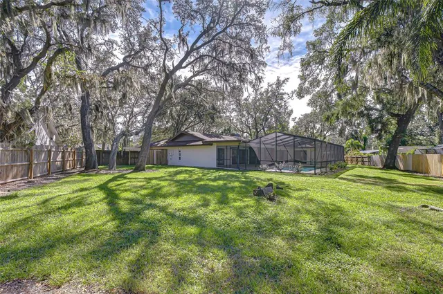 a house with a big yard and large trees