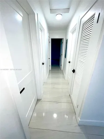 a view of a hallway with windows and stairs