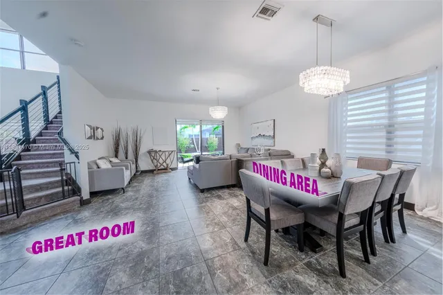 a view of a dining room with furniture wooden floor and a chandelier