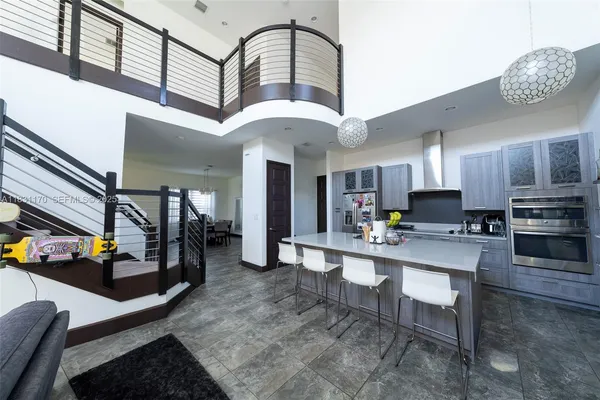 a kitchen with stainless steel appliances granite countertop a stove refrigerator and cabinets