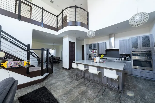 a kitchen with stainless steel appliances granite countertop a stove refrigerator and cabinets