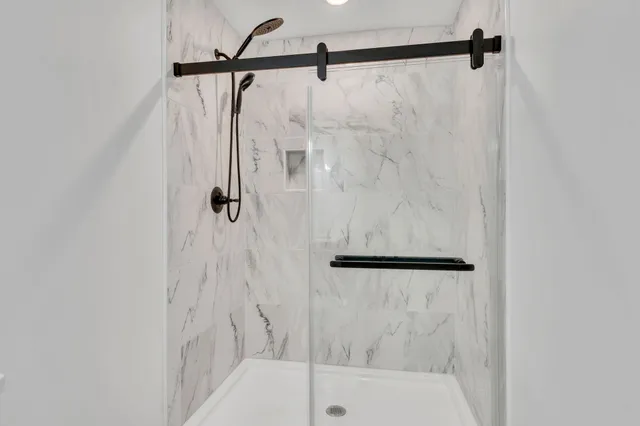 a bathroom with a shower and a bath tub