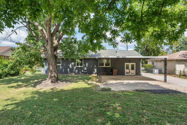 a house view with a sitting space and garden