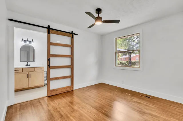 wooden floor in an empty room with a window
