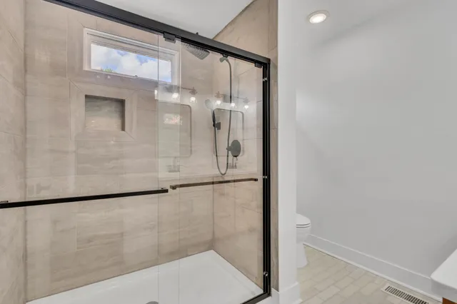 a bathroom with a glass shower door