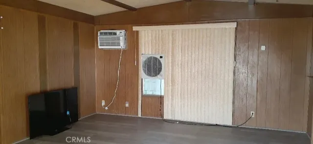 a view of a room with wooden floor and windows