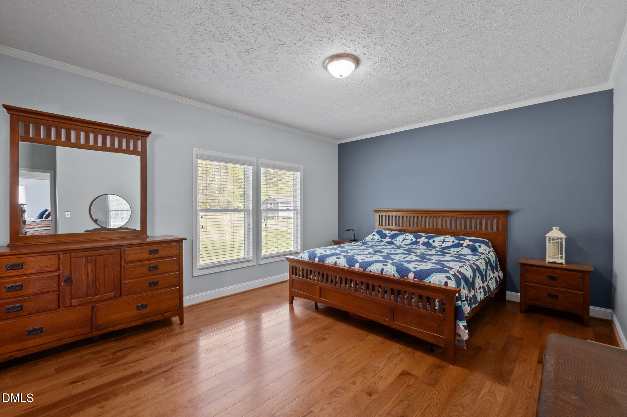 236 Dirgie Mine Road Roxboro, NC 27574 - Photo 29 of 55 a bedroom with a bed and wooden floor