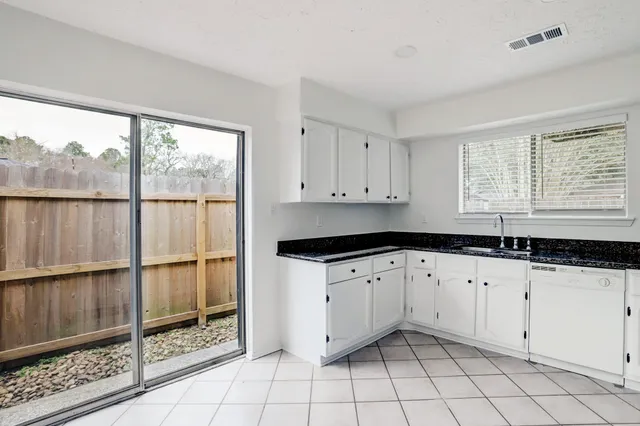 a kitchen with granite countertop a stove a sink and a granite counter tops