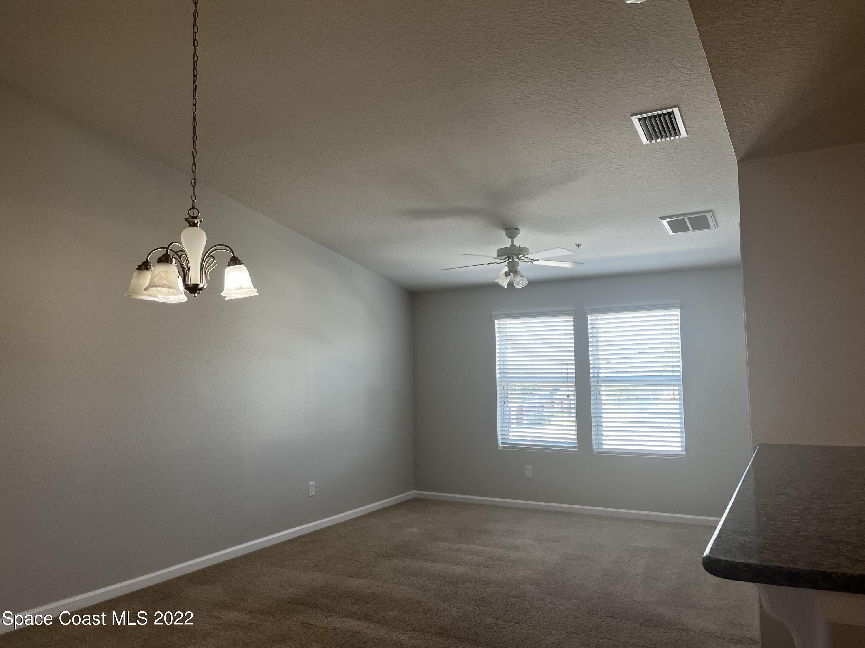 4127 Meander Place, Unit 203 Rockledge, FL 32955 - Photo 3 of 13 a view of an empty room with a window