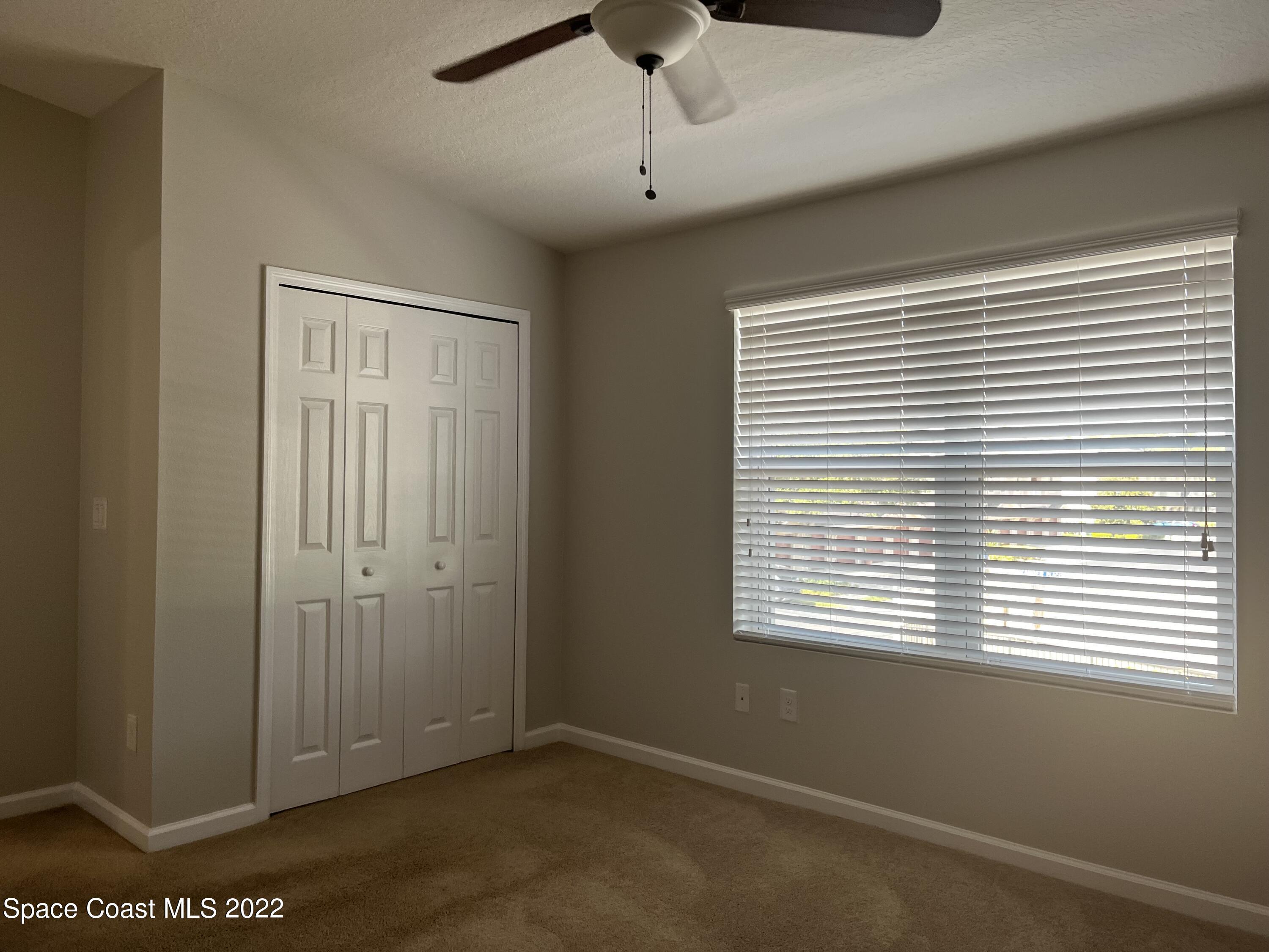 4127 Meander Place, Unit 203 Rockledge, FL 32955 - Photo 10 of 13 a view of an empty room with a window
