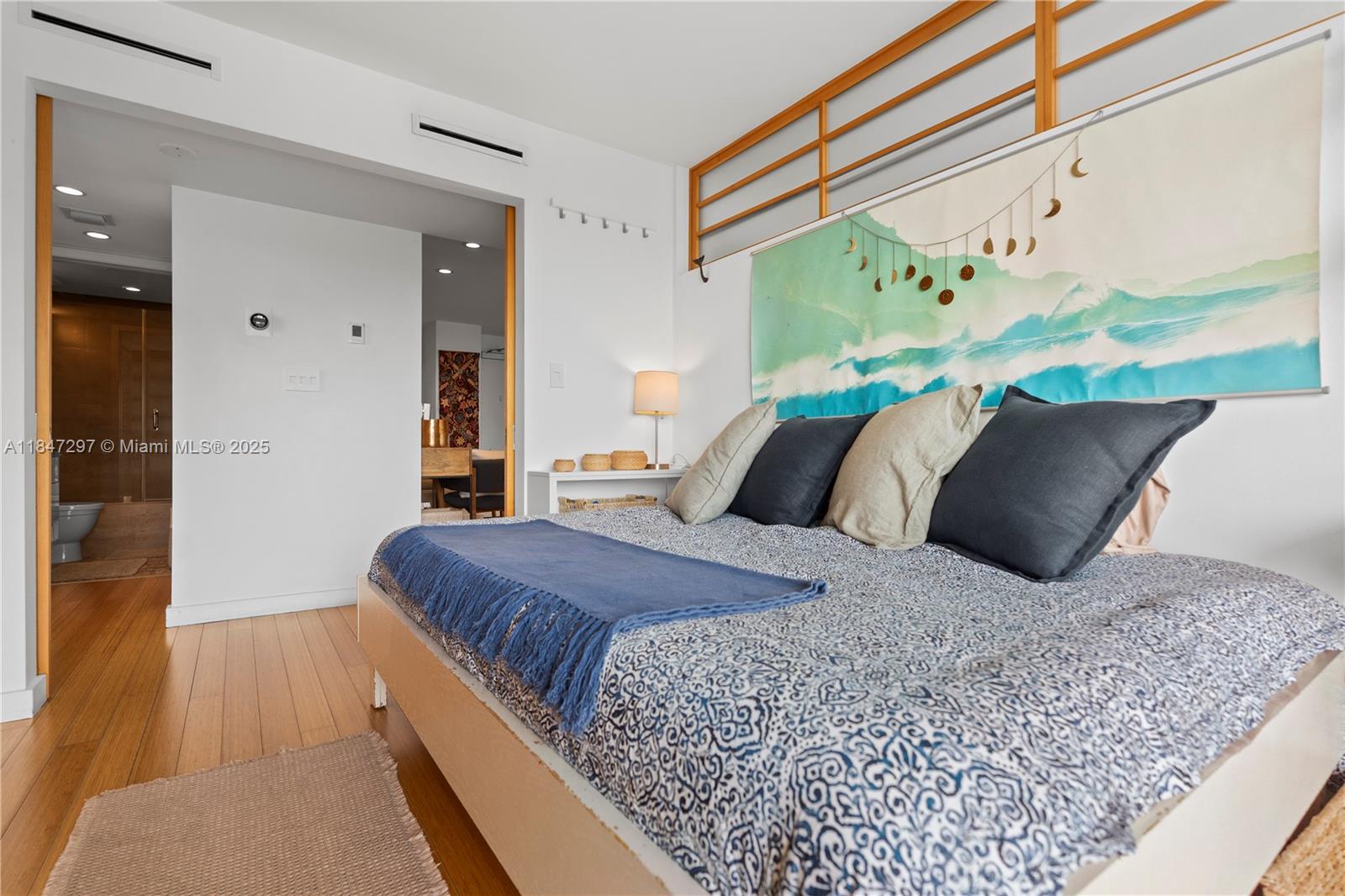 Brickell Miami, FL 33129 - Photo 24 of 42 a bedroom with a bed and wooden floor