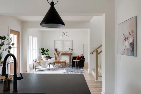 a dining room with furniture a window and a chandelier