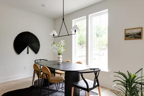 a kitchen with stainless steel appliances a stove a chimney a sink and cabinets