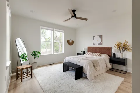 a bedroom with a bed and a chandelier