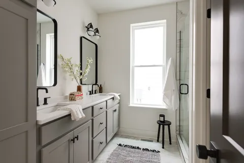 a view of a hallway with wooden floor and a window