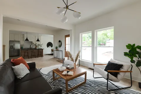 a kitchen with stainless steel appliances granite countertop a sink a stove and a wooden floors